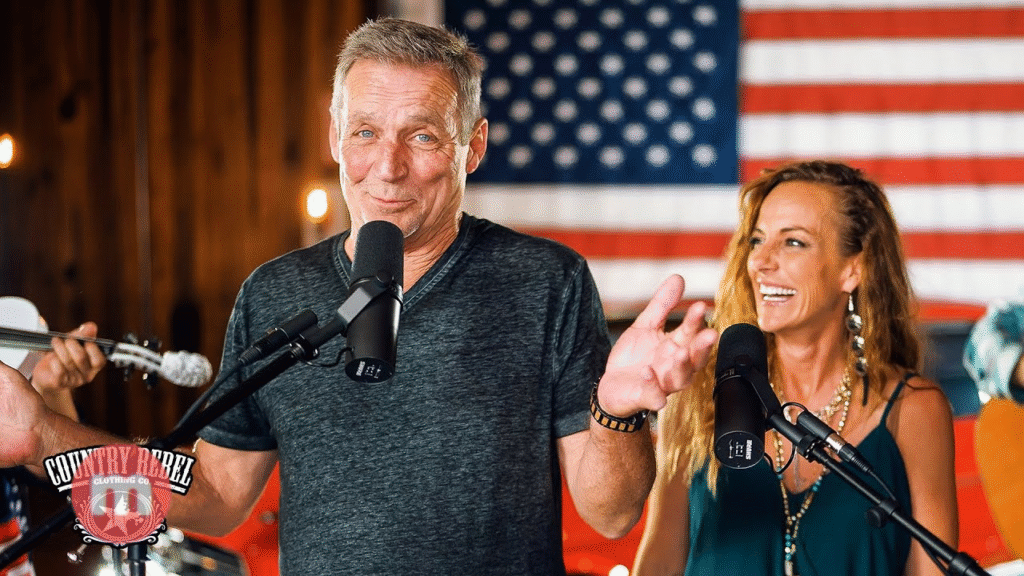 a man and woman standing in front of microphones